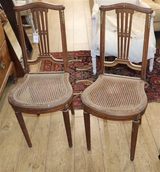 A pair of French caned salon chairs